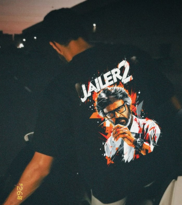 Model wearing the black JAILER 2 oversized jersey at night, showing the back print